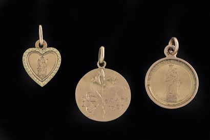 Set of three religious medals in yellow gold...