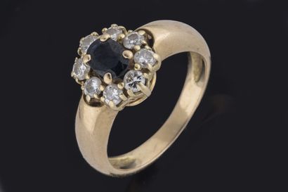 Daisy ring centered on an oval sapphire set...