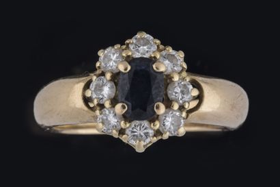 Daisy ring centered on an oval sapphire set...