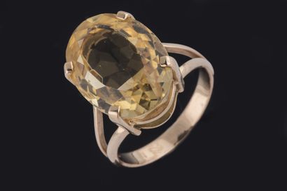 Ring set with an oval faceted citrine in...