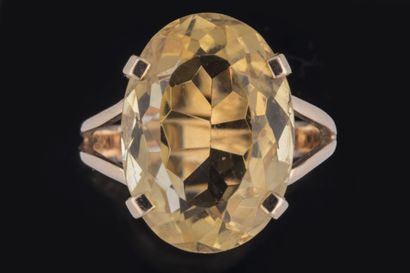 Ring set with an oval faceted citrine in...