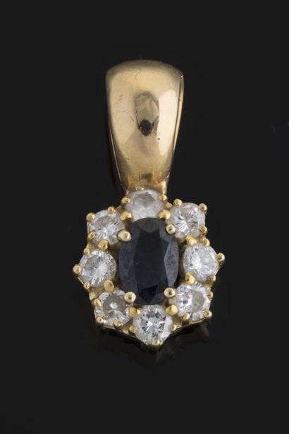 Daisy pendant centered on an oval sapphire...