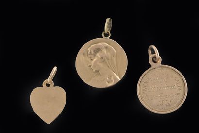Set of three religious medals in yellow gold...