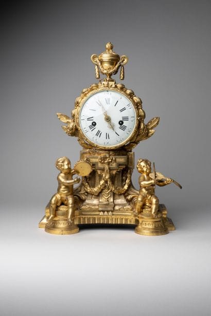 Child musician clock in chased and gilded...
