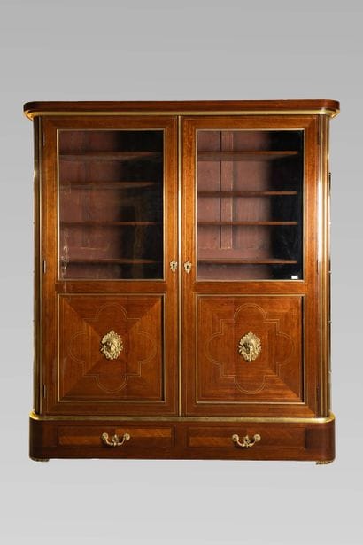 Bookcase in amaranth veneer inlaid with brass...