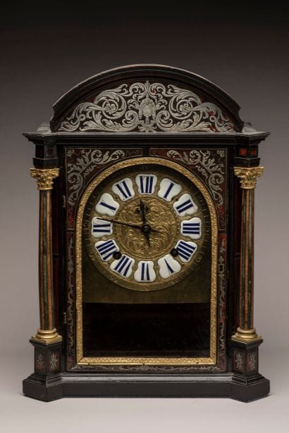 Religious clock with arched cornice in blackened...