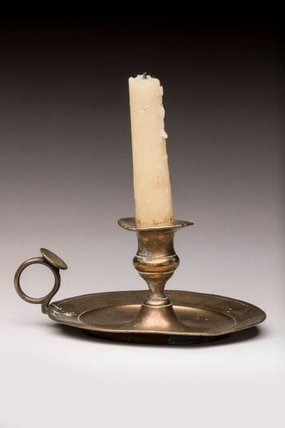 Yellow copper hand candlestick with thumb...