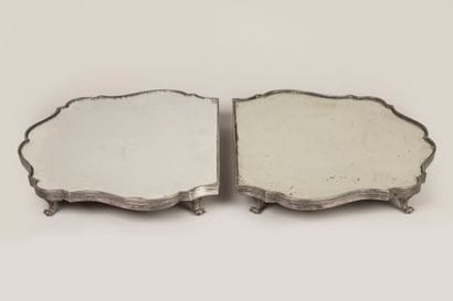 A two-part table top in silvered bronze with...