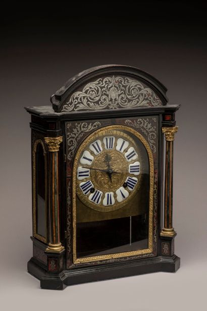 Religious clock with arched cornice in blackened...