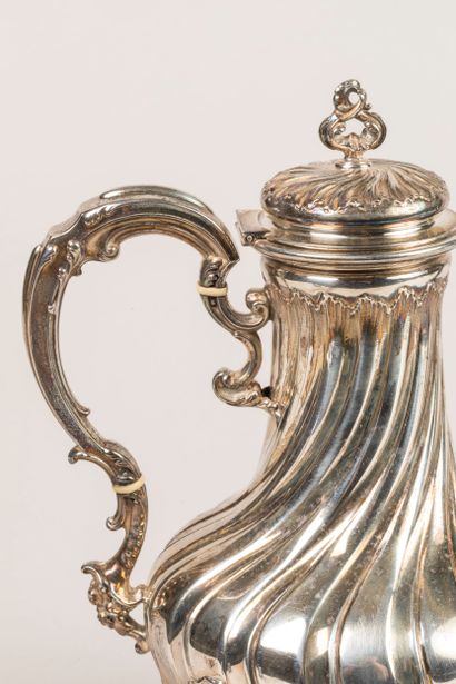 Four-legged silver coffee pot decorated with...
