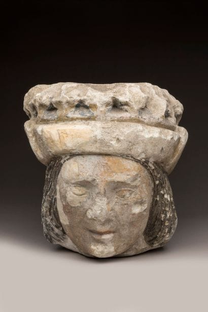 Crowned man's head in limestone (tufa), carved...