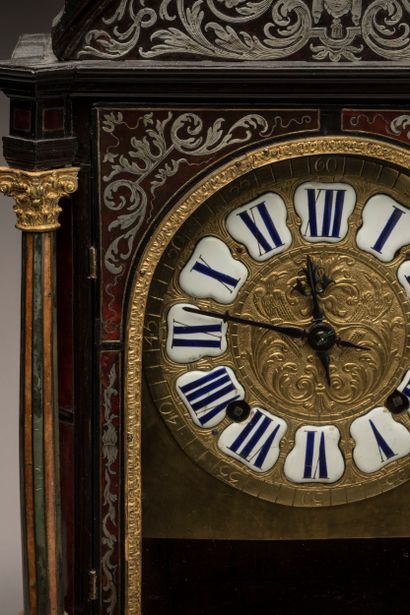 Religious clock with arched cornice in blackened...