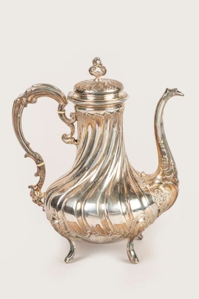Four-legged silver coffee pot decorated with...