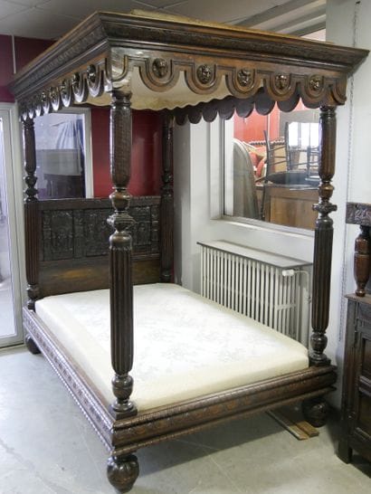 a single-headed canopy bed decorated with...