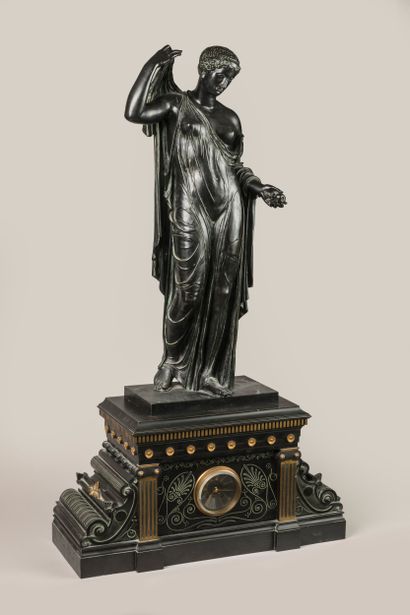 Patinated, gilded and engraved bronze clock...
