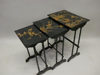 Three nesting tables in blackened wood decorated...