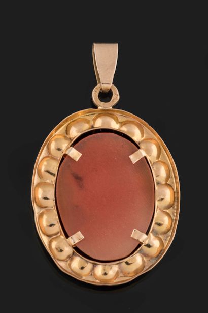 Oval pendant centered on a shell cameo with...