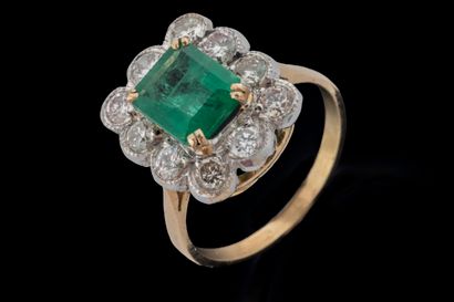 Rectangular ring centered on an emerald weighing...