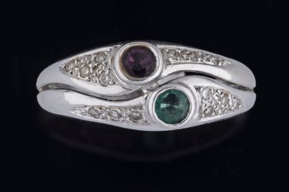Band ring set with a round faceted emerald...