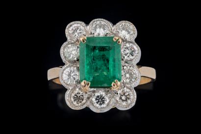 Rectangular ring centered on an emerald weighing...