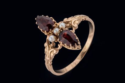 Marquise ring set with two pear-shaped garnets...