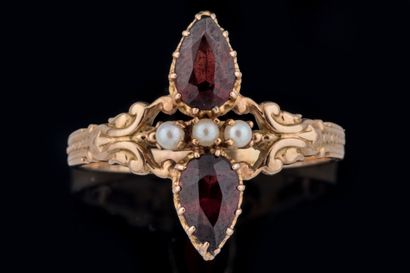Marquise ring set with two pear-shaped garnets...