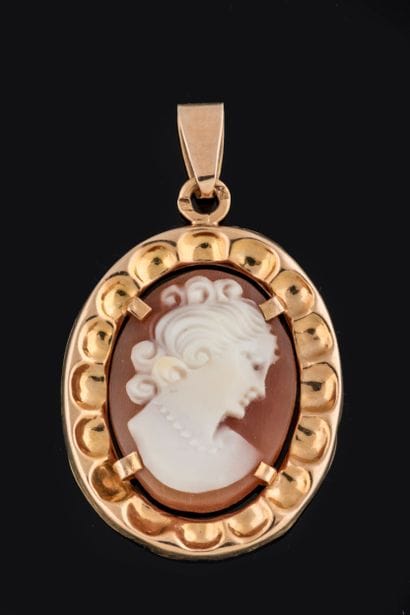 Oval pendant centered on a shell cameo with...