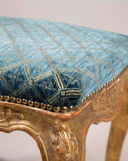 A quadrangular stool made of molded, carved,...