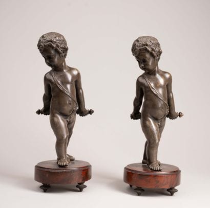 Two chiseled and patinated bronze putti,...