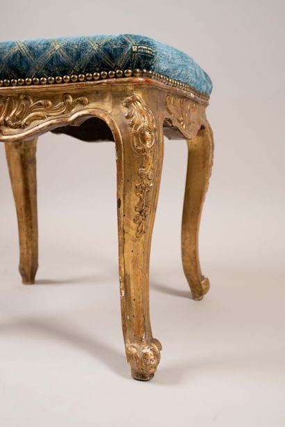 A quadrangular stool made of molded, carved,...