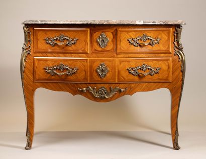 A Louis XV-style chest of drawers with two...