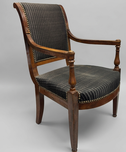 Armchair with a flat backrest featuring molded...