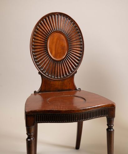 Pair of chairs with flat, circular backs...