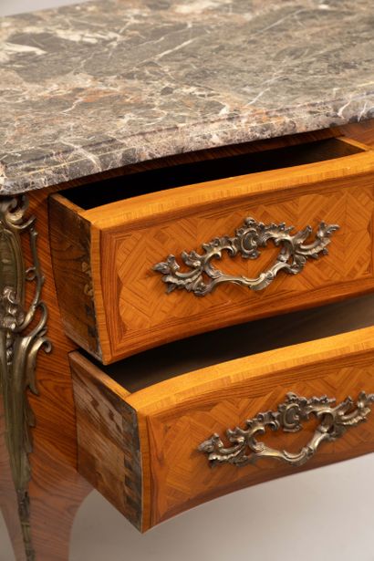A Louis XV-style chest of drawers with two...