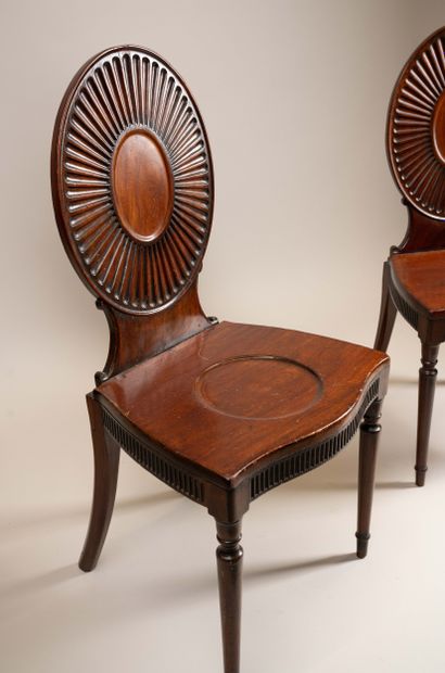 Pair of chairs with flat, circular backs...
