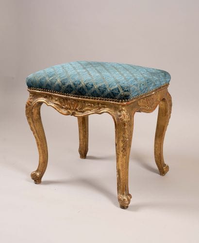 A quadrangular stool made of molded, carved,...