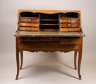 A sloping-top secretary desk made of molded...
