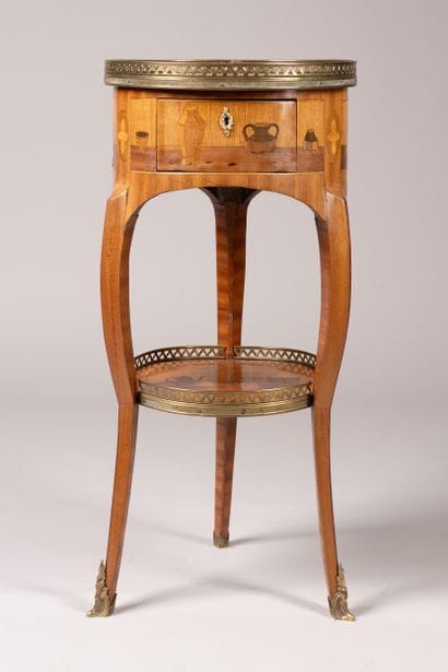 Drum table with a marquetry design featuring...
