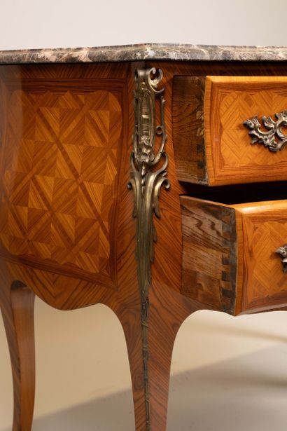 A Louis XV-style chest of drawers with two...