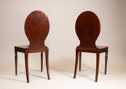 Pair of chairs with flat, circular backs...