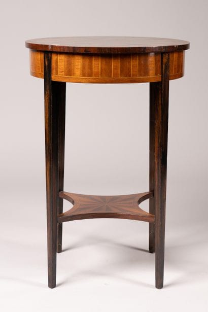 A circular table made of wood veneer with...