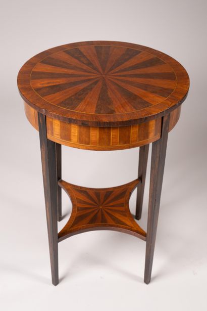 A circular table made of wood veneer with...