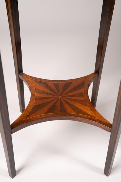 A circular table made of wood veneer with...