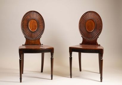 Pair of chairs with flat, circular backs...