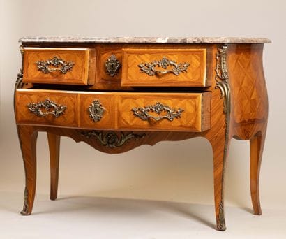 A Louis XV-style chest of drawers with two...