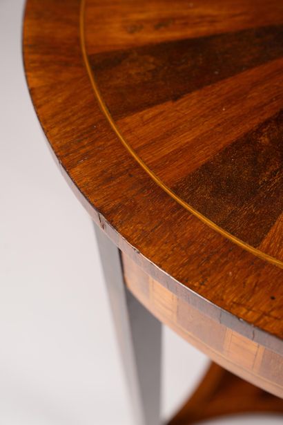 A circular table made of wood veneer with...