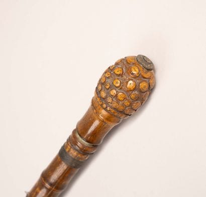 A large bamboo cane fitted with a hook and...