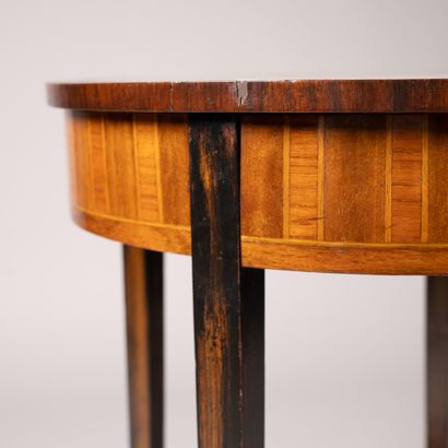 A circular table made of wood veneer with...