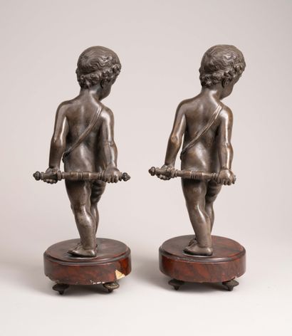 Two chiseled and patinated bronze putti,...