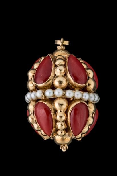 Large oblong pendant adorned with 10 red-tinted...